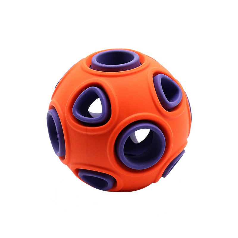 Illuminated Glow-in-the-Dark Squeaky Dog Ball glowing brightly in dark grass