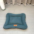 Small dog resting head on washable nest pad bed
