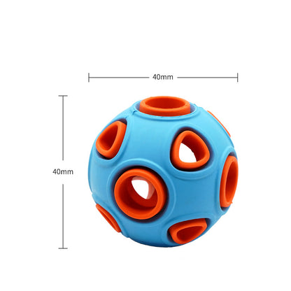 Illuminated Glow-in-the-Dark Squeaky Dog Ball glowing brightly in dark grass