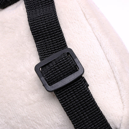 Black adjustable nylon bag strap with a rectangular buckle detail on a cream-colored bag.